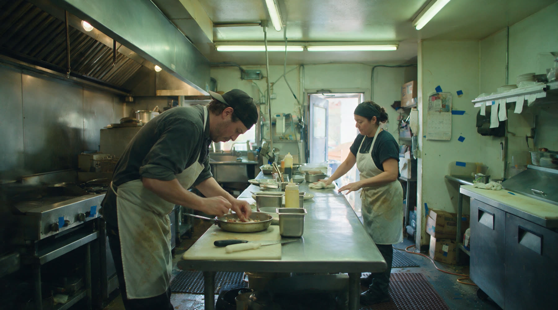 A diverse restaurant team celebrating together in the kitchen